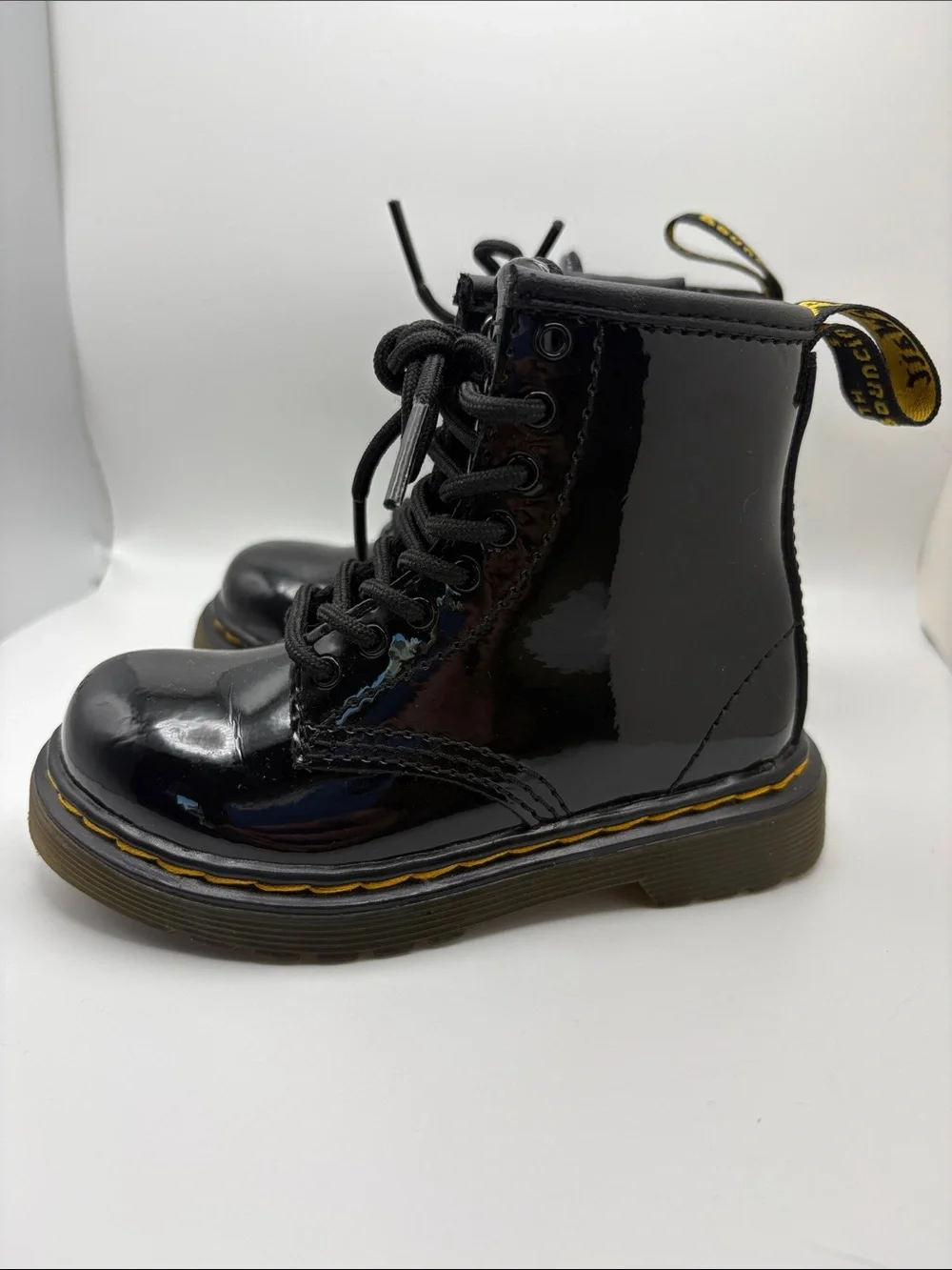 Dr. Martens Kids Glossy Black Patent Lace-Up Boots with Yellow Stitching